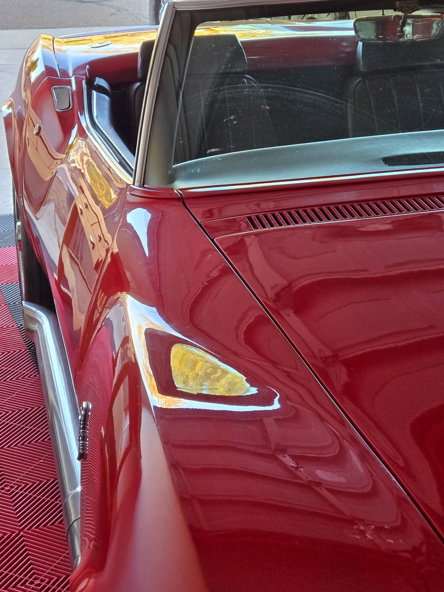 Restored red classic truck with chrome trim and yellow headlights displayed at ShuBrews Garage Bar Phoenix.