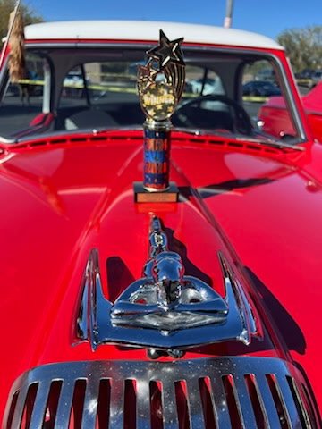 Vintage red car hood ornament and chrome detail displayed at ShuBrews Garage Bar in Phoenix.