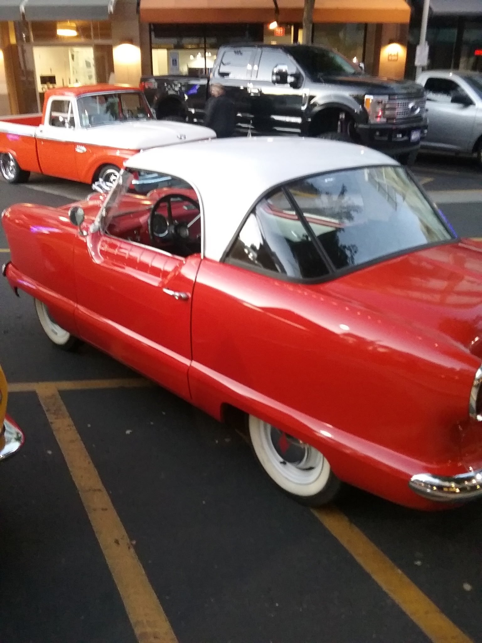 Classic red and white 1950s car parked outside ShuBrews Garage Bar in Phoenix, Arizona.