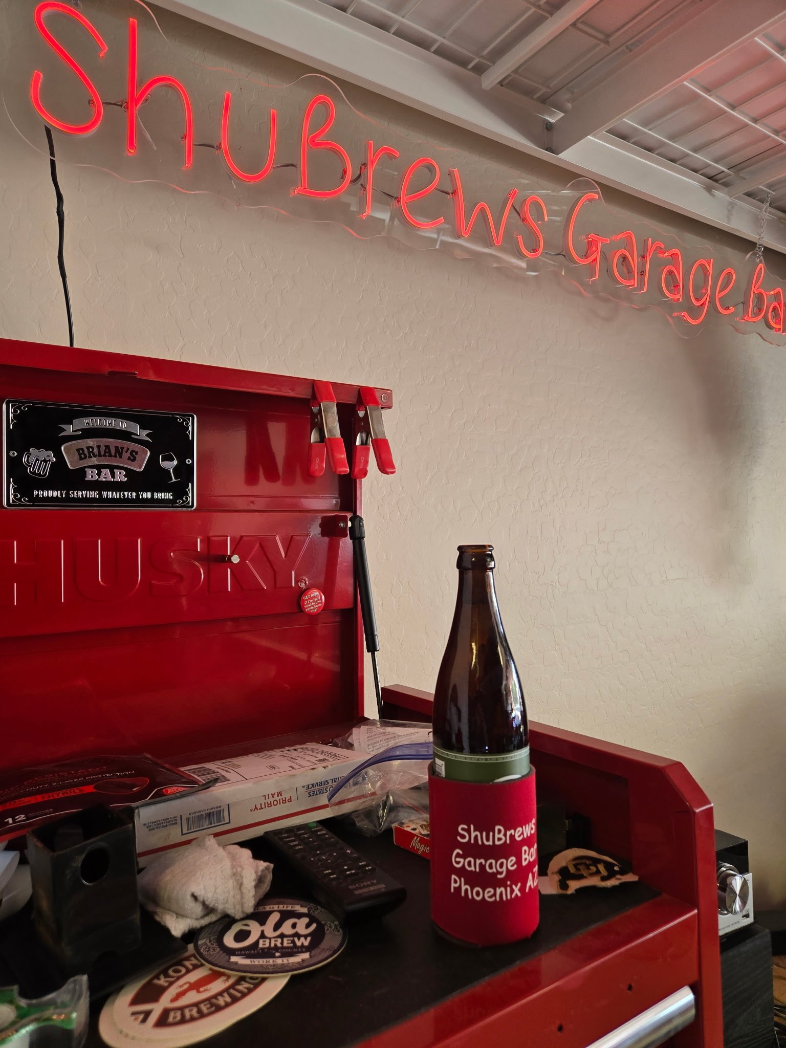 ShuBrews Garage Bar storefront featuring red neon sign, beer bottle, and Brian's Bar signage in Phoenix.